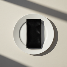 Load image into Gallery viewer, Black velvet napkin arranged on a plain white plate
